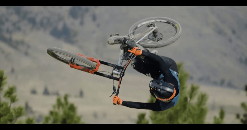 Ciclista in downhill che affronta una discesa ripida su un percorso montano.