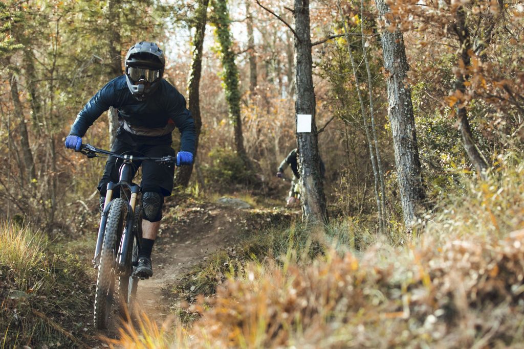 Downhill mtb cyclist descending down mountain track