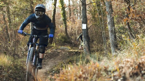 Downhill mtb cyclist descending down mountain track